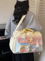 Person carrying a pastel-colored bag with star and bow designs.