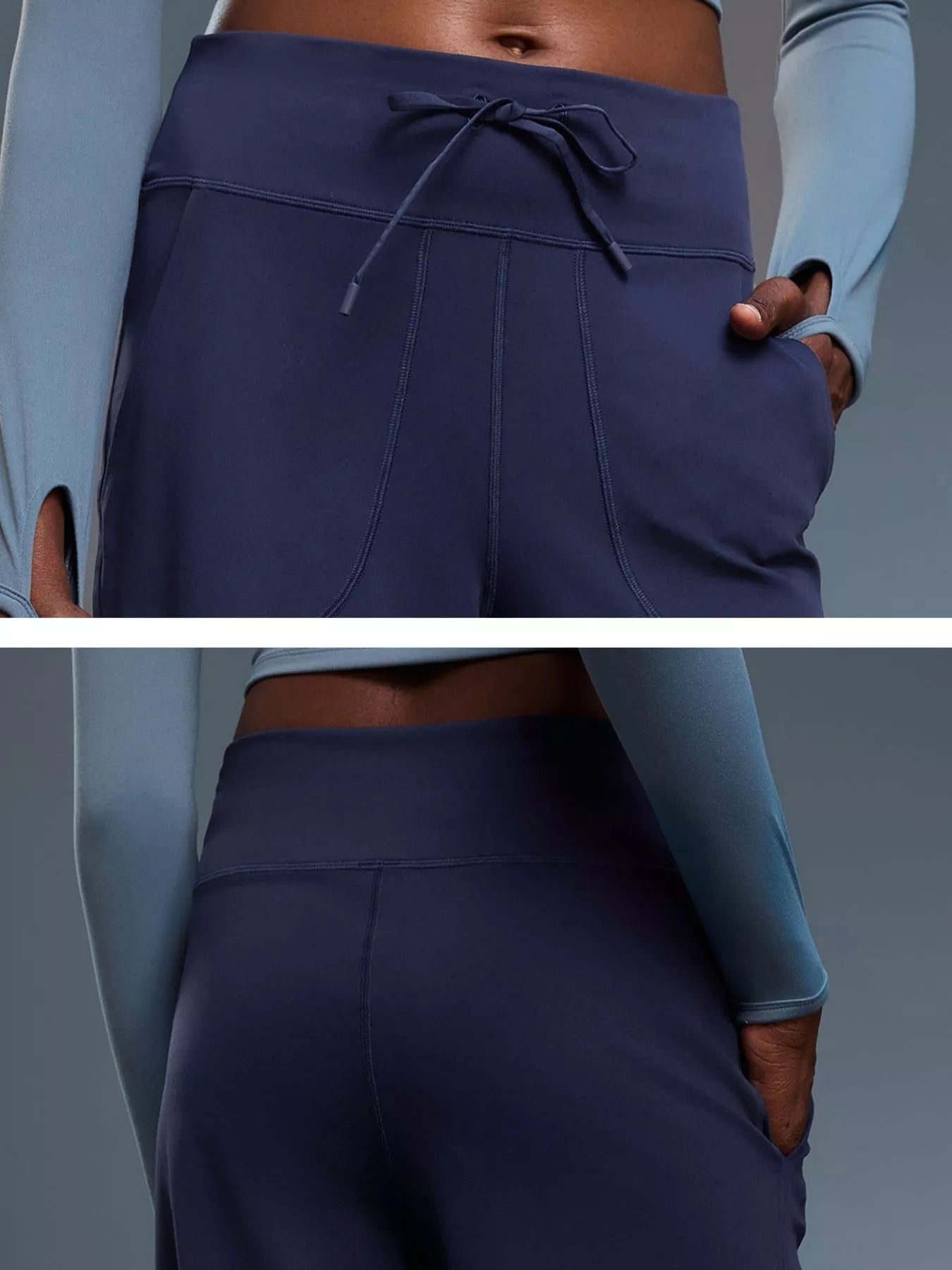 Navy blue athletic pants with a drawstring waistband on a gray background