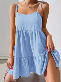 Light blue dress with thin straps on a neutral background