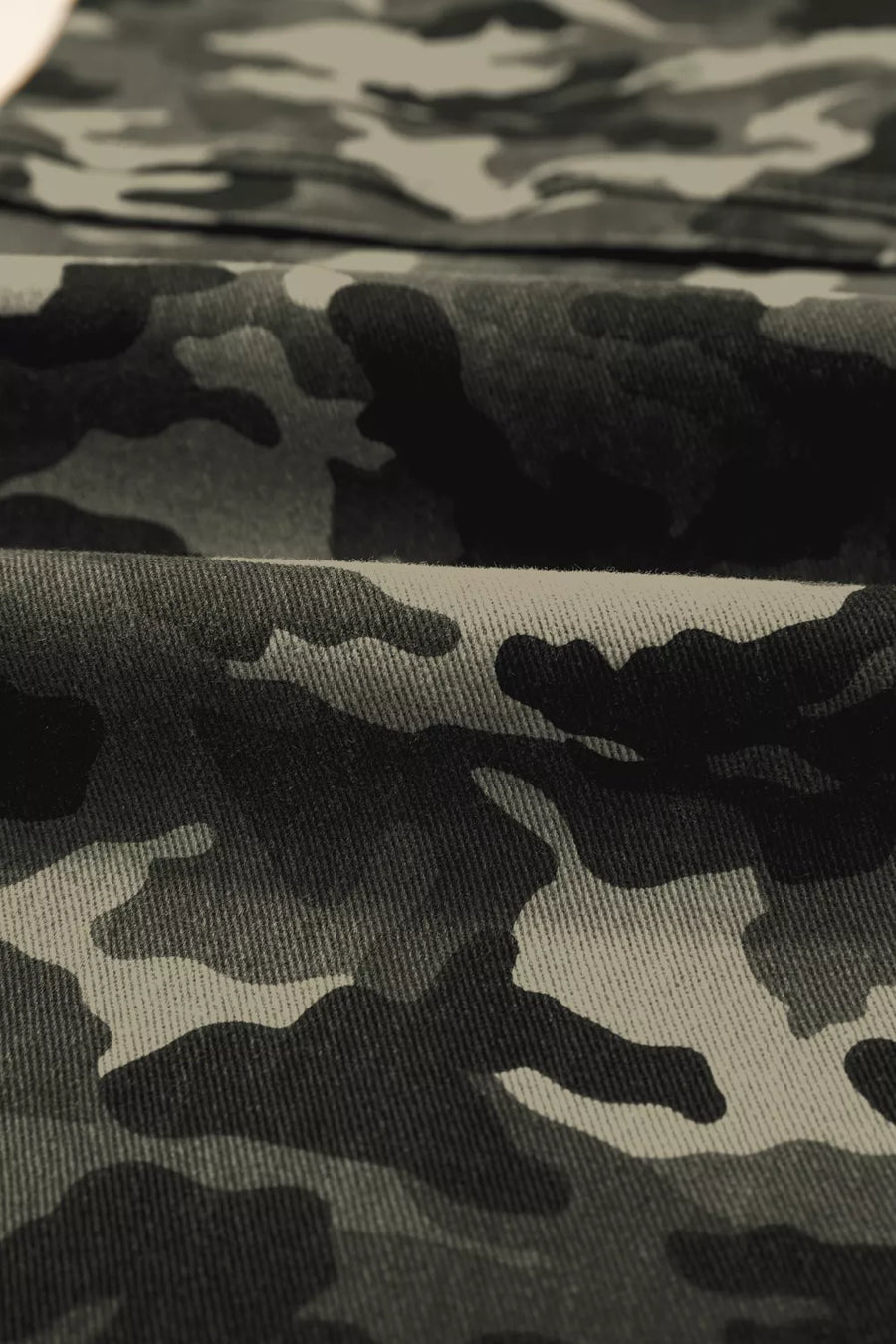 Close-up of camouflage fabric with black and gray pattern