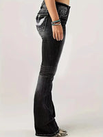 Black flared jeans worn by a person on a white background