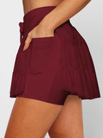 Maroon shorts worn by a person on a plain background