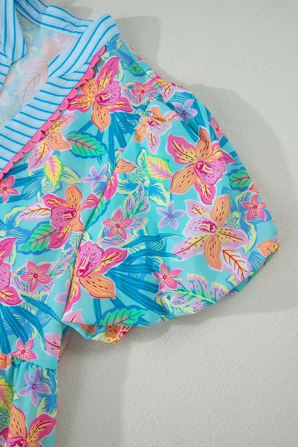 Colorful floral swimsuit on a light gray background