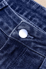 Close-up of a blue denim button on fabric
