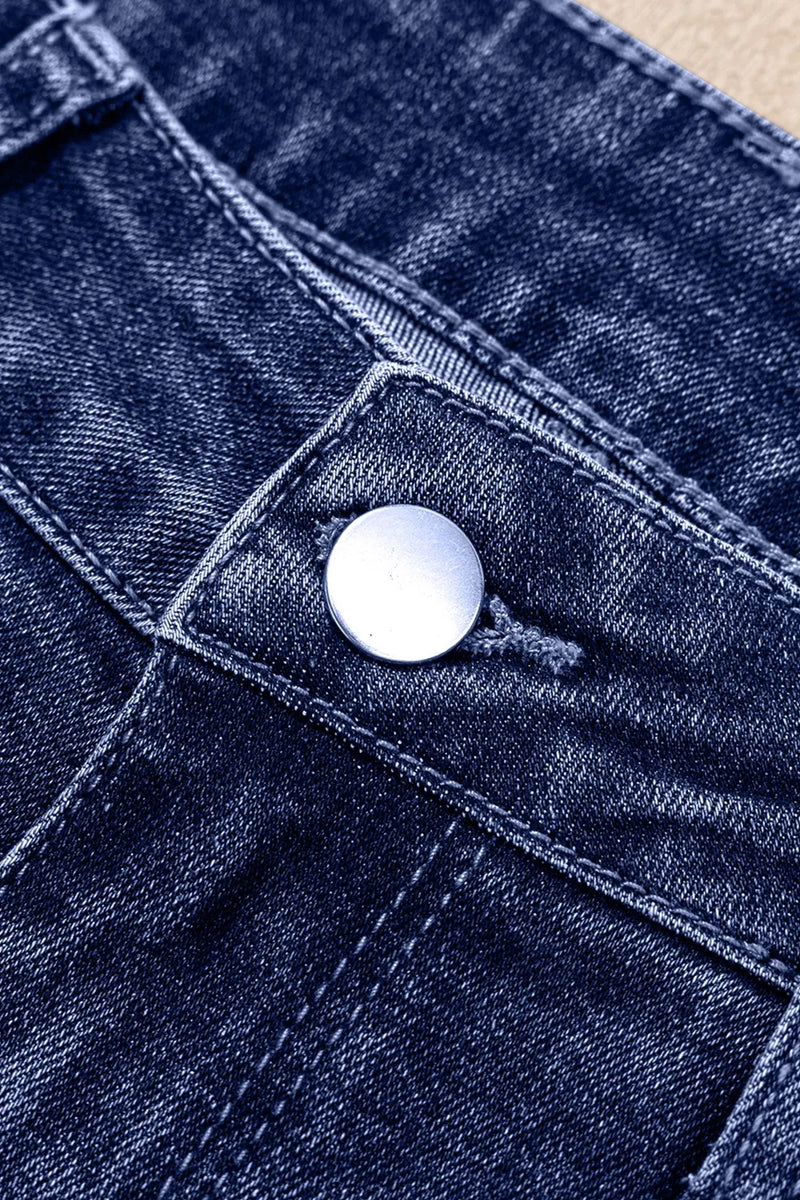 Close-up of a blue denim button on fabric
