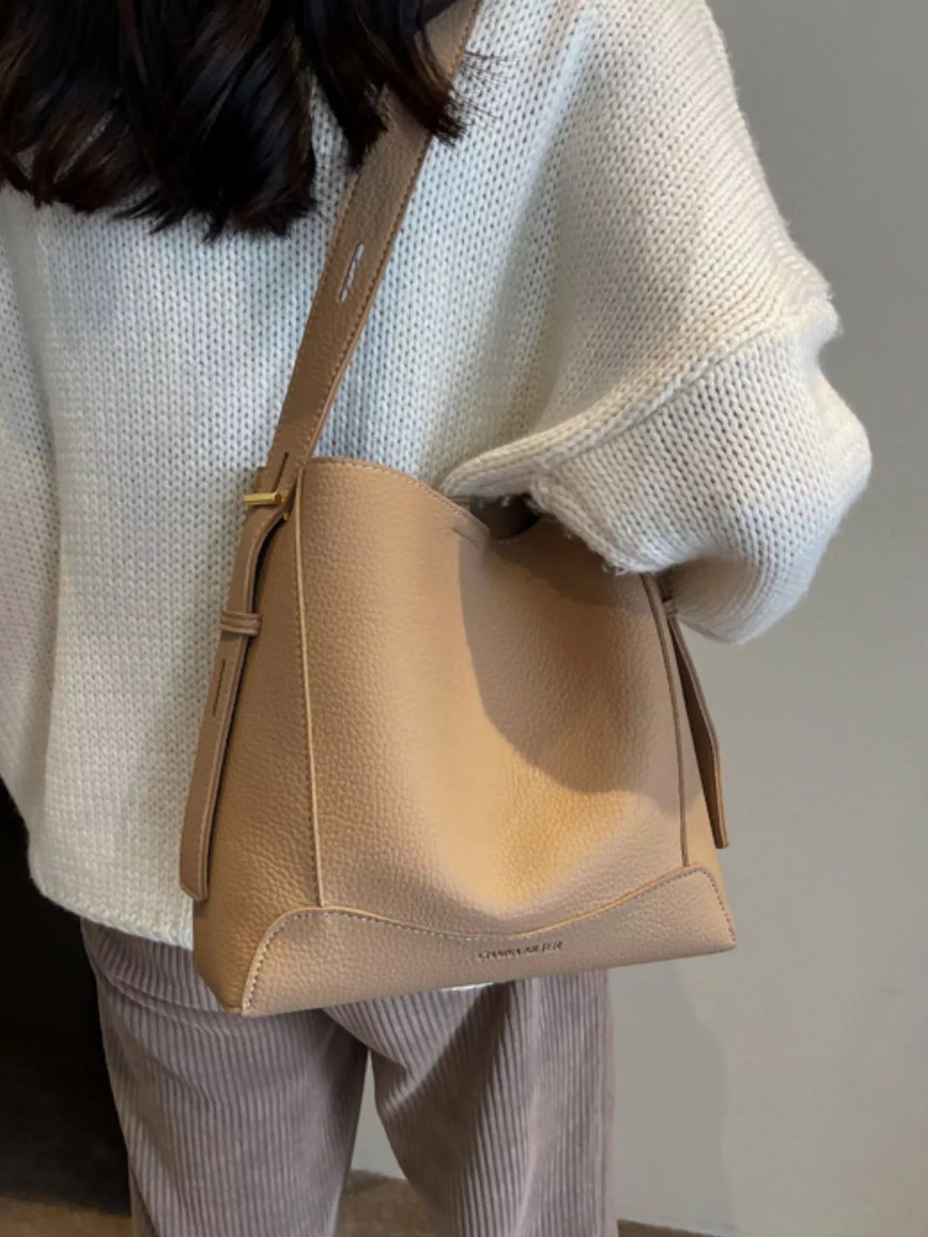 Lady showing Women's Leather Adjustable Strap Crossbody Bag