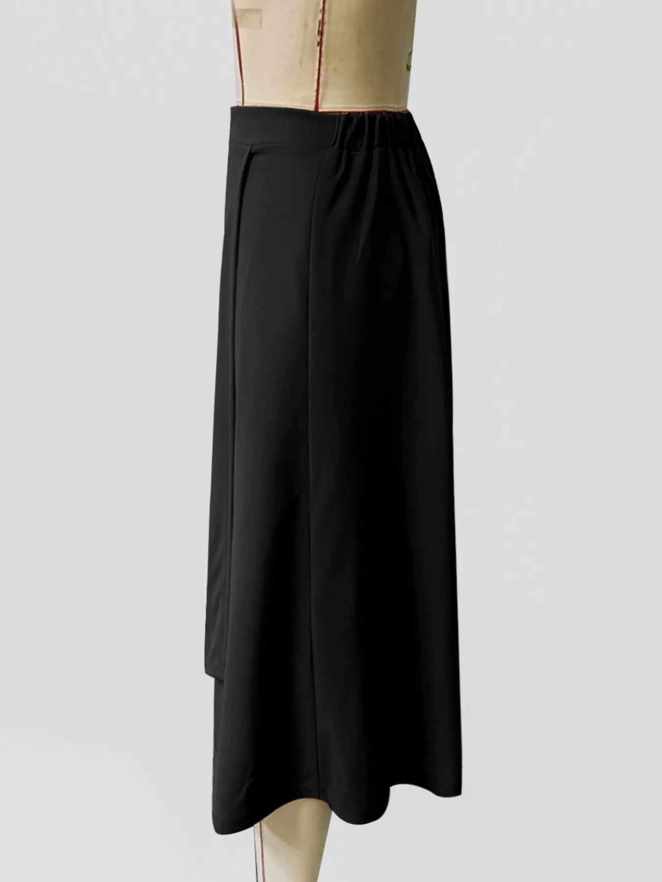 Black skirt on a mannequin against a white background