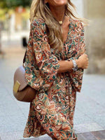 Woman wearing a patterned dress with a blurred background