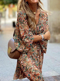 Woman wearing a patterned dress with a blurred background