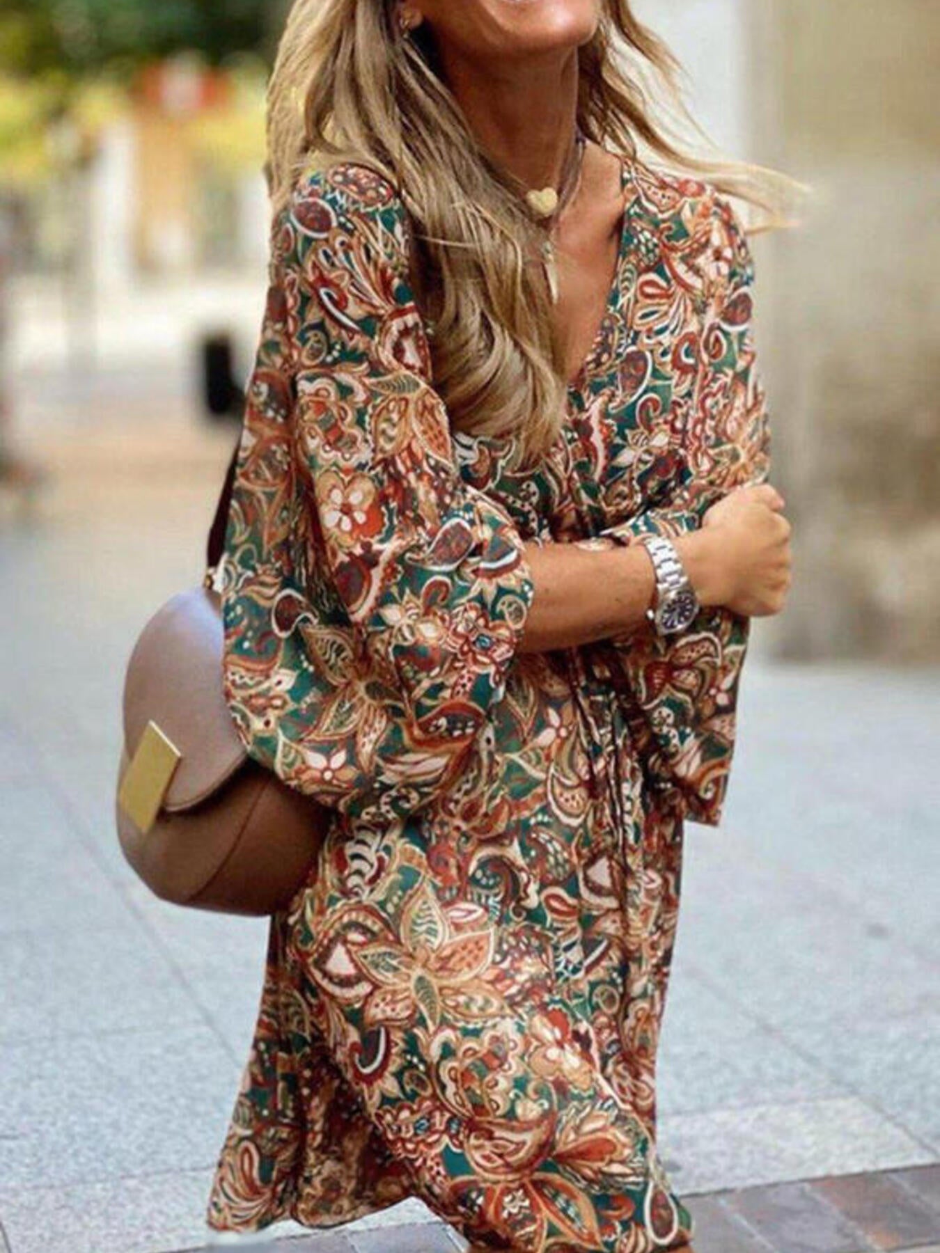 Woman wearing a patterned dress with a blurred background