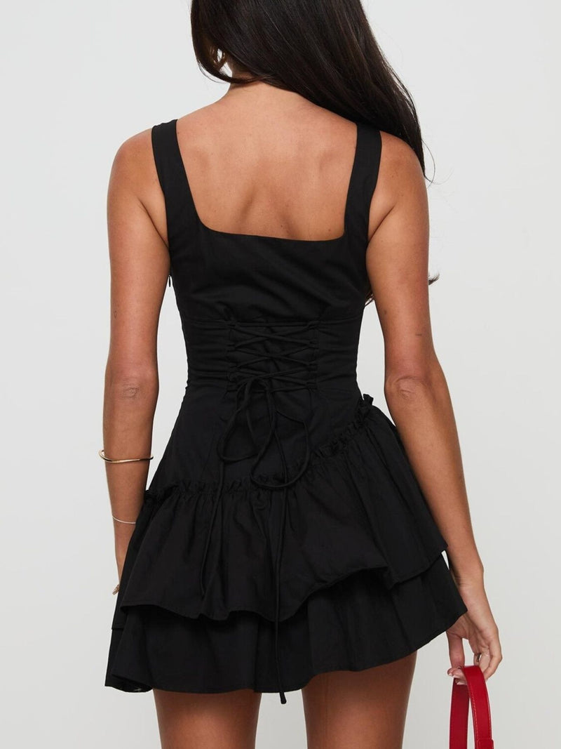 Black dress with ruffled layers on a plain background