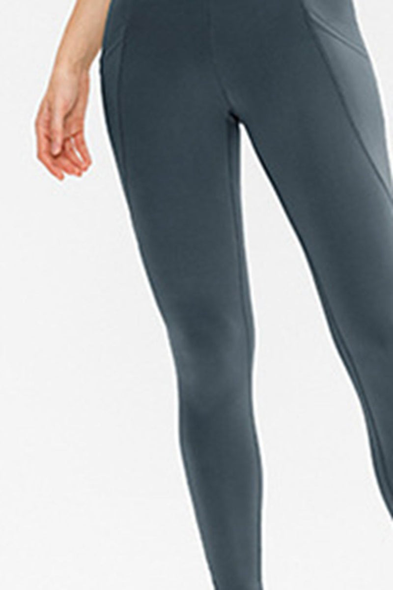 Gray leggings worn by a person on a white background