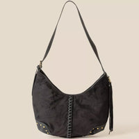 Black suede handbag with braided detail on a beige background