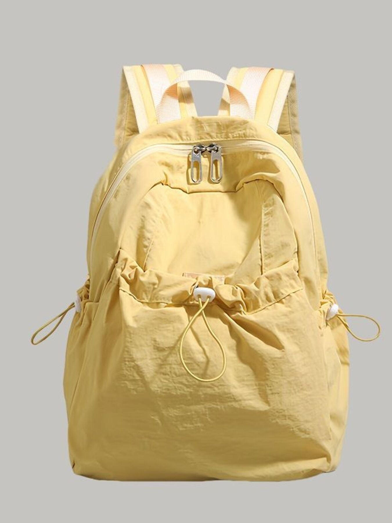 Yellow backpack on a gray background