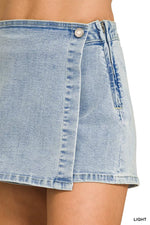 Light blue denim skirt worn by a person, with a close-up view of the fabric.
