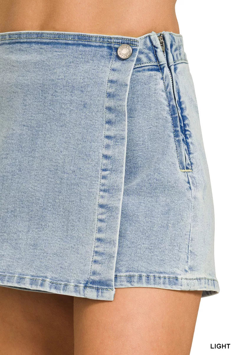Light blue denim skirt worn by a person, with a close-up view of the fabric.