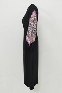 Black abaya with a colorful patterned scarf on a white background