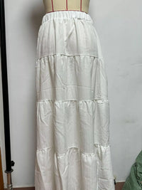 White tiered skirt on a mannequin against a plain background