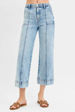 Light blue jeans worn by a person on a white background