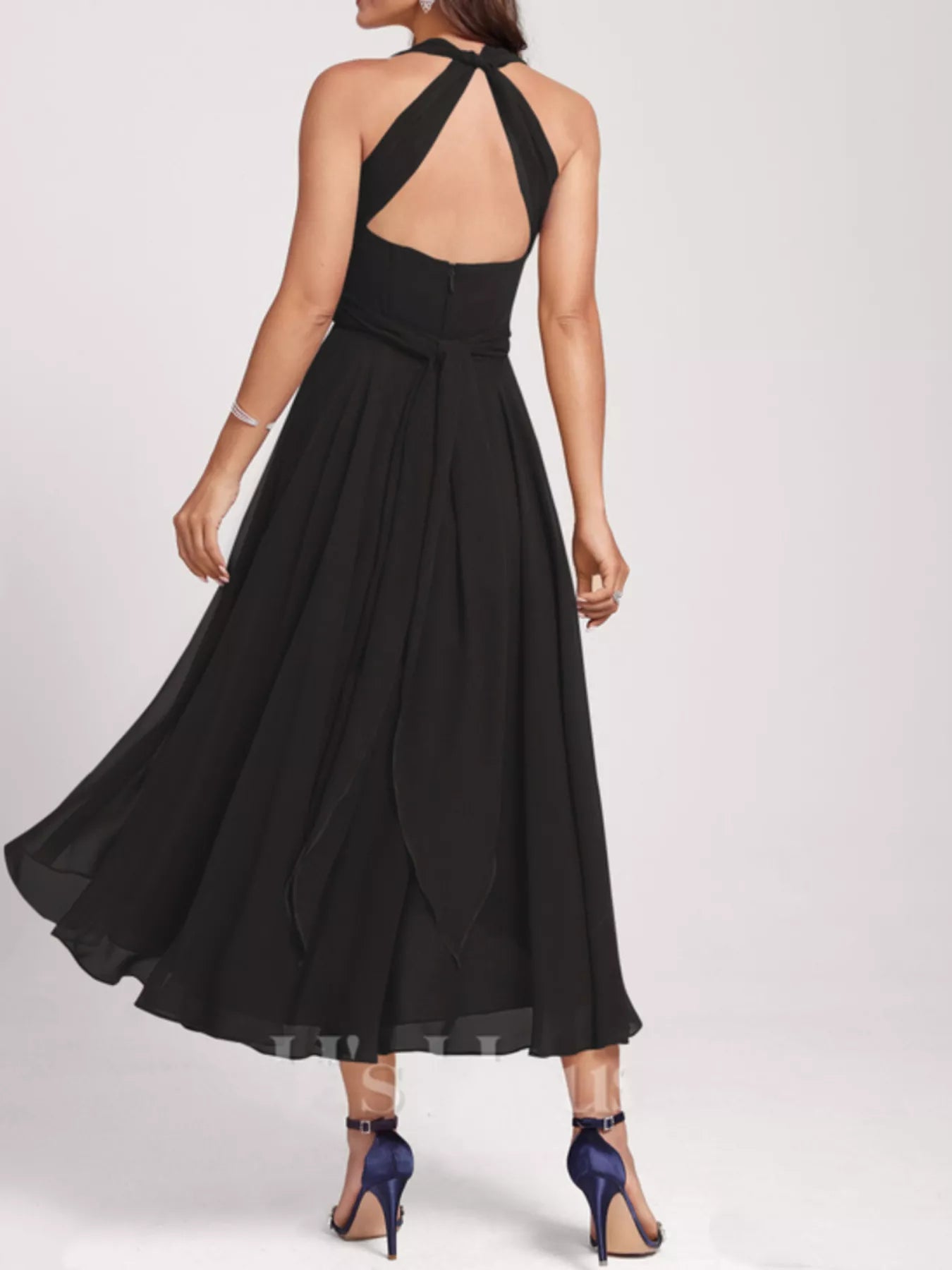 Black halter neck dress with a flowing skirt on a white background