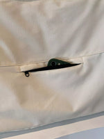 Close-up of a beige fabric with a zipper pocket