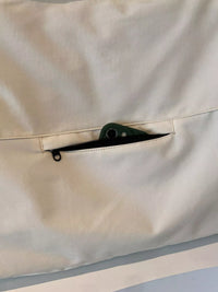 Close-up of a beige fabric with a zipper pocket