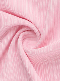 Close-up of pink ribbed fabric with a swirling pattern