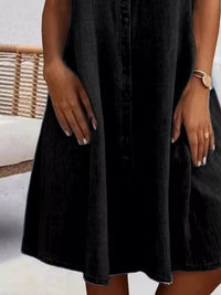 Black dress worn by a person with a blurred background