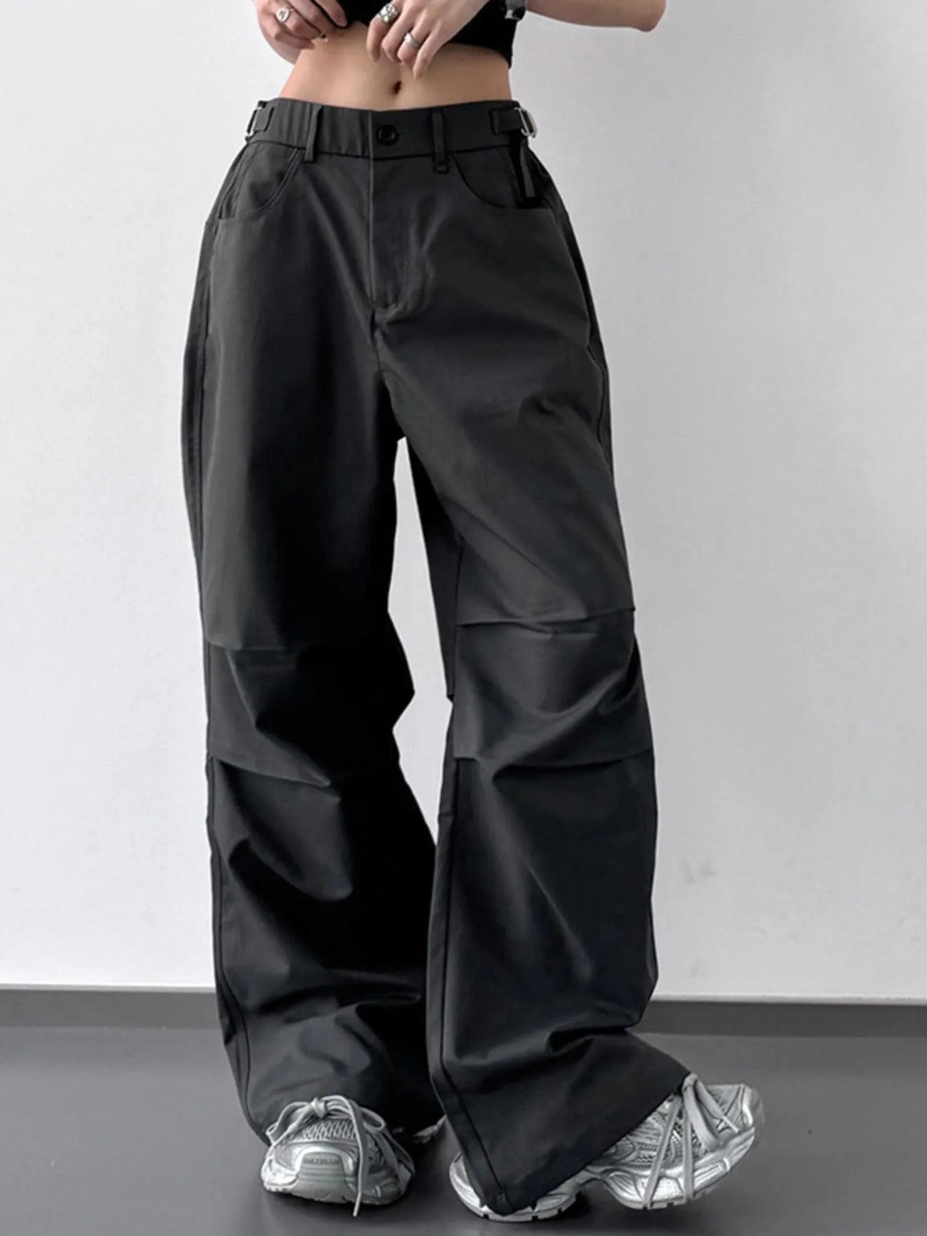 Black wide-leg pants worn by a person on a plain background