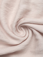Close-up of light pink fabric with a swirl pattern
