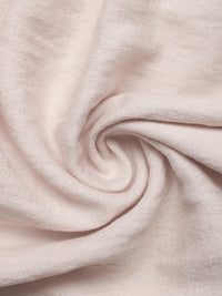 Close-up of light pink fabric with a swirl pattern