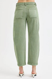 Green jeans worn by a person on a white background