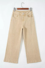 Beige pants on a hanger against a white background