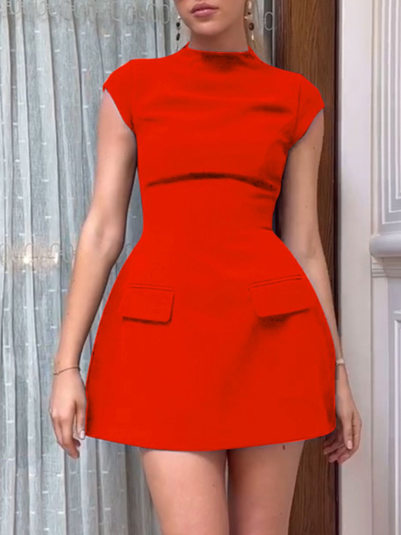Red dress worn by a person with a neutral background