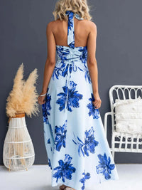 Woman wearing a blue floral dress against a gray background
