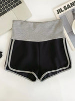 Black shorts with gray waistband on a white surface
