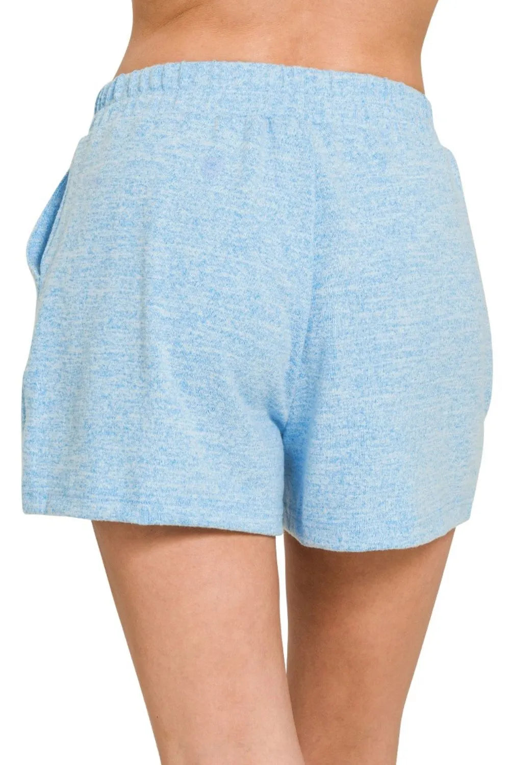 Light blue shorts worn by a person on a white background