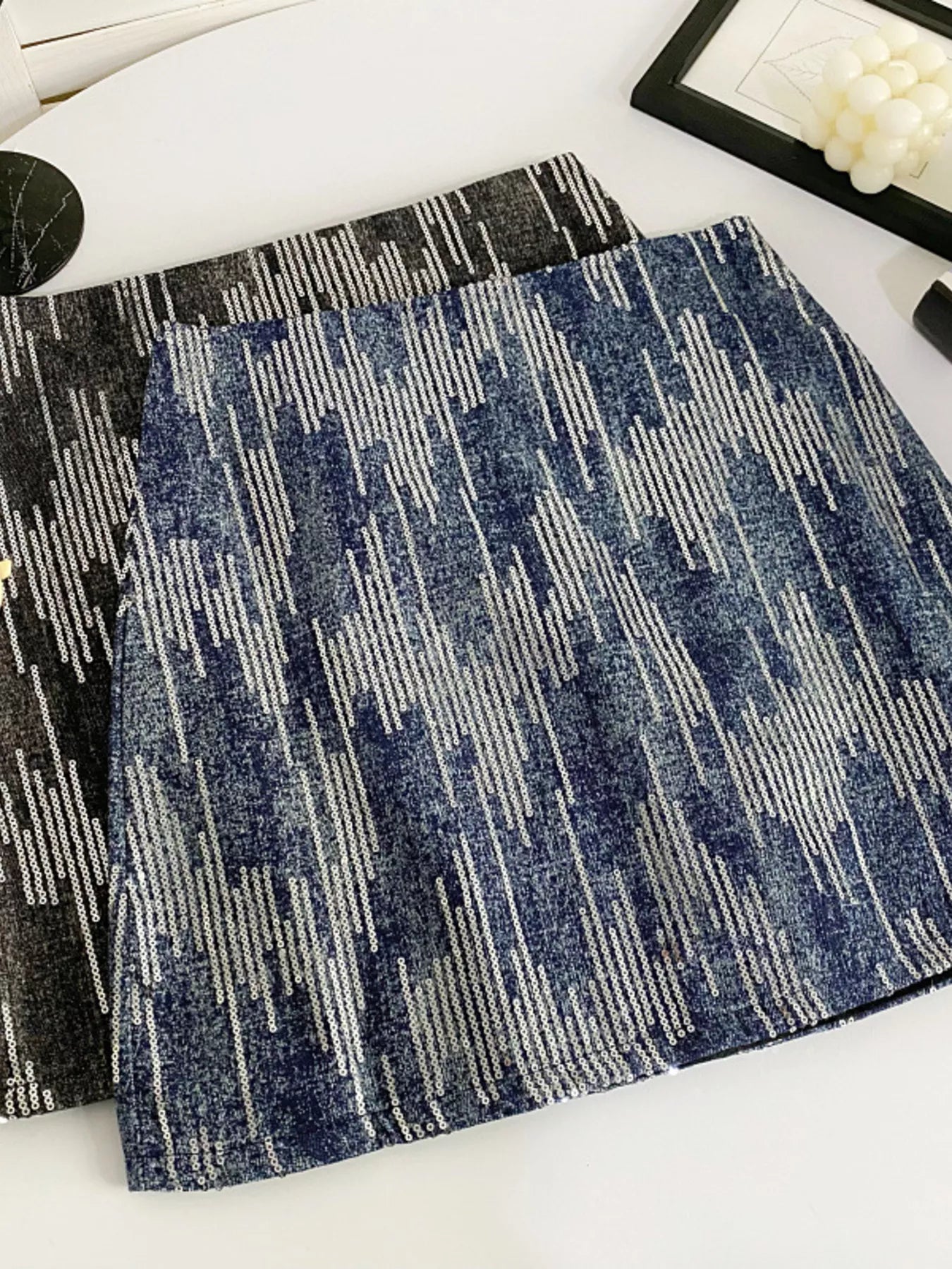 Two textured placemats with geometric patterns on a white surface.