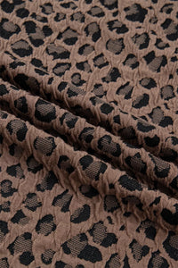 Close-up of brown fabric with black leopard print pattern