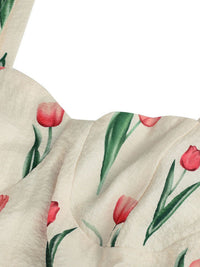 Close-up of a fabric with red tulip pattern on a white background
