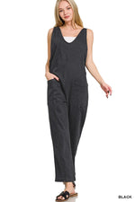 Woman wearing a dark gray jumpsuit on a white background