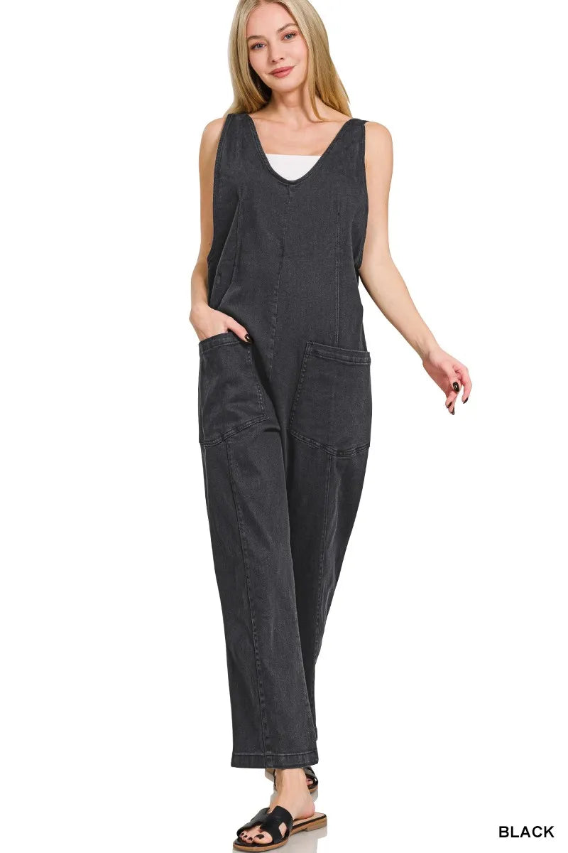Woman wearing a dark gray jumpsuit on a white background