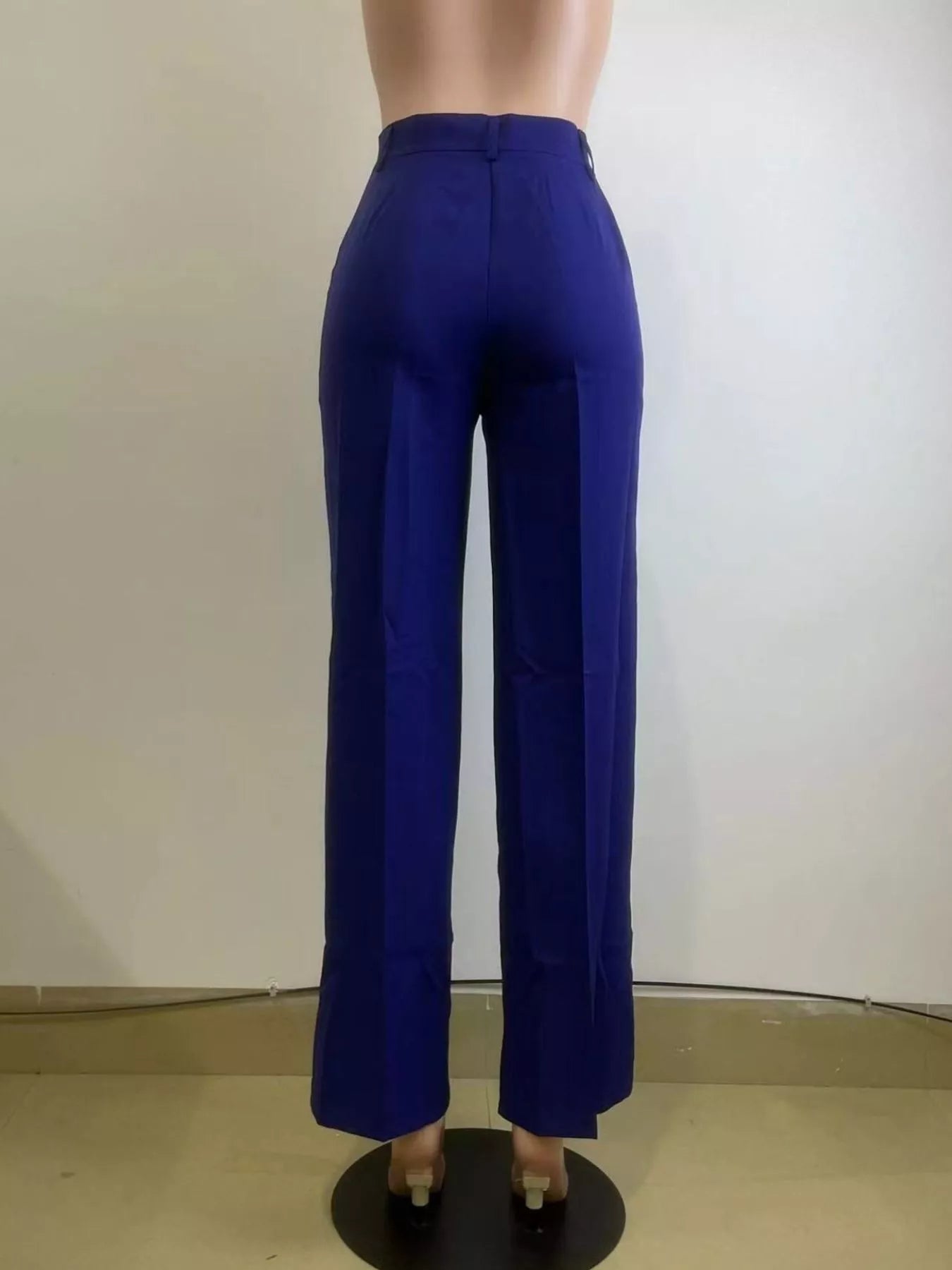 Blue pants on a mannequin against a plain background
