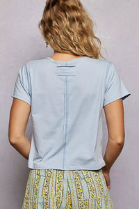 Light blue t-shirt worn by a person with a neutral background