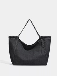 Black handbag with a chain strap on a light gray background