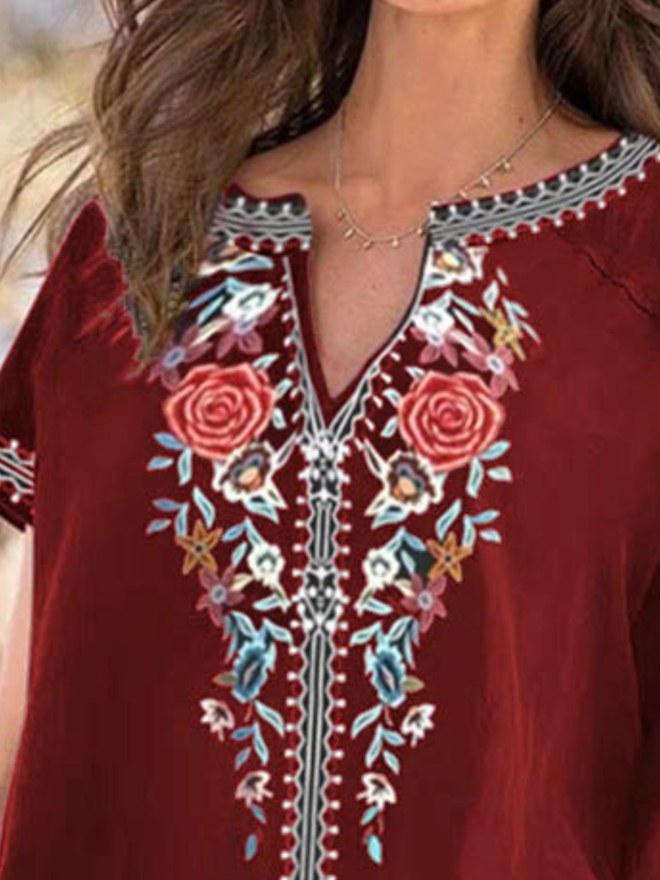 Close-up of a red embroidered top with floral patterns