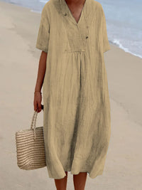 Person wearing a beige dress on a beach
