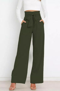 Green wide-leg pants with a white top on a white background