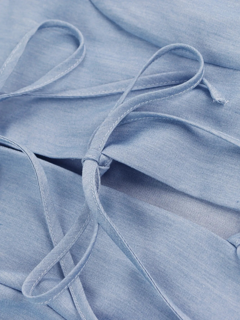 Close-up of light blue fabric with a focus on texture and pattern