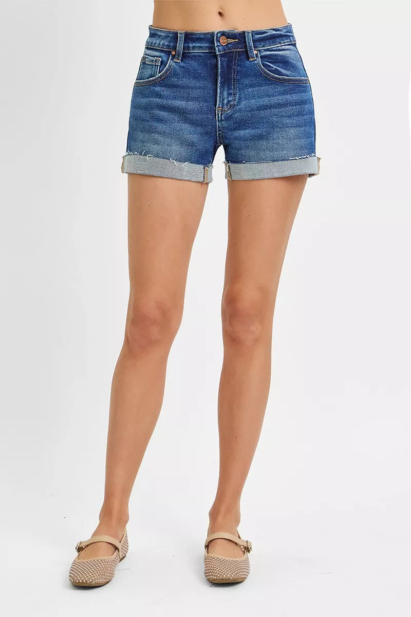 Denim shorts worn by a person on a white background